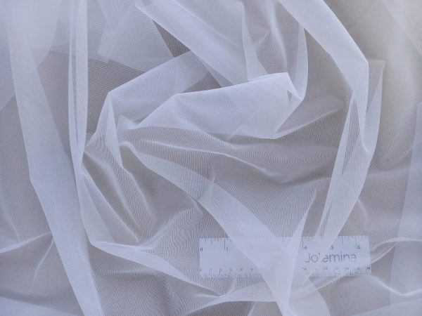 white non stretch sheer fabric folded with ruler
