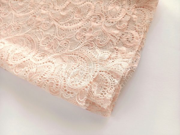 beige light pink stretch corded lace fabric folded